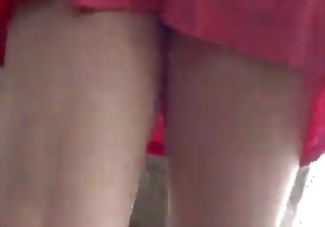 A cute lady in a short dress shows off her impressive bottom