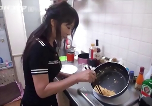 Good Asian chick is doing some kitchen stuff in a hot way